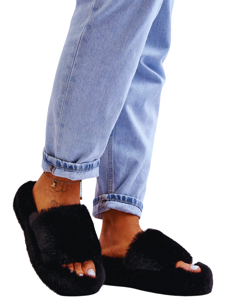 Cozy black faux fur slippers paired with light blue jeans.